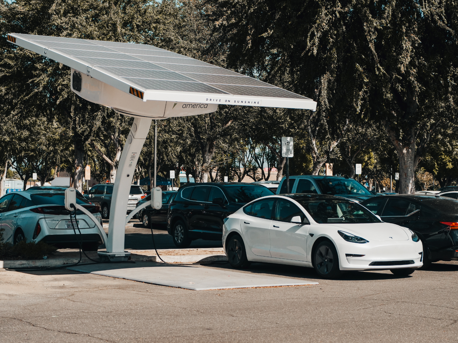 Electric car on charge underneath a Solar Panel Car Port